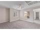 Spacious bedroom offering plenty of natural light, modern ceiling fan, and neutral carpeting at 6712 Biltmore Garden St, Las Vegas, NV 89149