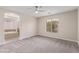 Spacious bedroom with neutral carpet, ceiling fan, and ensuite bathroom with soaking tub at 6712 Biltmore Garden St, Las Vegas, NV 89149