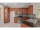 Well-equipped kitchen featuring stainless steel appliances, rich wood cabinets, and mosaic backsplash at 6712 Biltmore Garden St, Las Vegas, NV 89149
