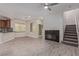 Cozy living area with fireplace, adjacent to an open kitchen and staircase for easy access at 6712 Biltmore Garden St, Las Vegas, NV 89149