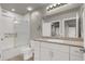 Well-lit bathroom with granite counters, white cabinets, and modern shower with glass doors at 7305 Halo Falls St, North Las Vegas, NV 89084