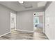 Bright bedroom features modern gray walls, wood-look floors, and access to ensuite bathroom and second bedroom at 7305 Halo Falls St, North Las Vegas, NV 89084