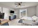 Neutral bedroom provides ample natural light, dark dresser, and a ceiling fan at 7305 Halo Falls St, North Las Vegas, NV 89084