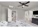 The bedroom boasts a ceiling fan, TV, walk-in closet, and neutral walls at 7305 Halo Falls St, North Las Vegas, NV 89084