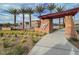 Valley Vista community entrance with desert landscaping, monument sign, and well-maintained street at 7305 Halo Falls St, North Las Vegas, NV 89084