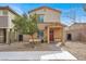 Inviting two-story home featuring a charming front porch and low-maintenance landscaping at 7305 Halo Falls St, North Las Vegas, NV 89084