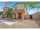 Charming home with a welcoming red door, covered porch, and low-maintenance front yard at 7305 Halo Falls St, North Las Vegas, NV 89084