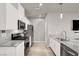 Modern kitchen with white cabinets, stainless appliances, and sleek countertops for a contemporary look at 7305 Halo Falls St, North Las Vegas, NV 89084
