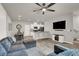Open-concept living area featuring modern decor, wood-look floors, and seamless flow to kitchen at 7305 Halo Falls St, North Las Vegas, NV 89084