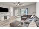 Comfortable living room with plush seating, stylish decor, and natural light from the window at 7305 Halo Falls St, North Las Vegas, NV 89084