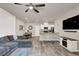 Modern living area featuring an open floor plan connecting the living room, dining area, and kitchen at 7305 Halo Falls St, North Las Vegas, NV 89084