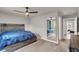 Spacious main bedroom offering a large bed, ceiling fan, and convenient closet access at 7305 Halo Falls St, North Las Vegas, NV 89084