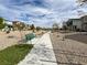 Community walking path with desert landscaping, seating, shade trees, and manicured lawn at 7305 Halo Falls St, North Las Vegas, NV 89084