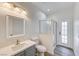 Modern bathroom with glass shower, gray vanity, and updated fixtures at 7900 Holly Knoll Ave, Las Vegas, NV 89129