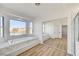 Bathroom with a luxurious soaking tub, a large window, and a glass enclosed shower at 7900 Holly Knoll Ave, Las Vegas, NV 89129