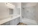 Bathroom with sleek white marble tile in shower, under mount sink with gray cabinetry and modern vanity lighting at 7900 Holly Knoll Ave, Las Vegas, NV 89129