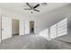 Sunlit bedroom with two closets featuring gray carpeting and neutral walls at 7900 Holly Knoll Ave, Las Vegas, NV 89129