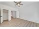 Bright bedroom with light wood floors, ceiling fan, and closet at 7900 Holly Knoll Ave, Las Vegas, NV 89129