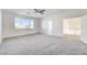 Bright bedroom with plush carpeting, a ceiling fan, and a large window with beautiful views at 7900 Holly Knoll Ave, Las Vegas, NV 89129