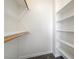 Interior shot of a spacious closet with shelving and a wooden clothes rack at 7900 Holly Knoll Ave, Las Vegas, NV 89129