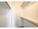 A large carpeted walk-in closet featuring wood racks and shelving at 7900 Holly Knoll Ave, Las Vegas, NV 89129