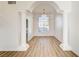 Spacious dining room featuring arched entryway, columns, and wood-look floors at 7900 Holly Knoll Ave, Las Vegas, NV 89129