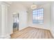Formal dining room with large windows and elegant wood-look flooring at 7900 Holly Knoll Ave, Las Vegas, NV 89129