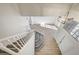 View from above showcases stairway and entryway with wood floors, carpeted stairs and modern light fixture at 7900 Holly Knoll Ave, Las Vegas, NV 89129