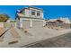 Two-story home featuring a three car garage, desert landscaping and concrete driveway in a residential neighborhood at 7900 Holly Knoll Ave, Las Vegas, NV 89129
