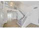 Bright, open foyer with high ceilings, staircase, and wood-look flooring at 7900 Holly Knoll Ave, Las Vegas, NV 89129