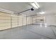 Three car garage with epoxy flooring, shelving and garage door openers for easy access at 7900 Holly Knoll Ave, Las Vegas, NV 89129