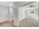Hallway leading to a bedroom with wood-look floors and natural light at 7900 Holly Knoll Ave, Las Vegas, NV 89129