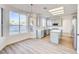 Open concept kitchen and dining area with light wood floors and ample natural light at 7900 Holly Knoll Ave, Las Vegas, NV 89129