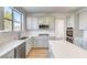 Bright kitchen features white cabinets, stainless steel appliances, quartz countertops, and a large island at 7900 Holly Knoll Ave, Las Vegas, NV 89129