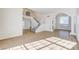 Spacious living room with wood-look flooring and a staircase at 7900 Holly Knoll Ave, Las Vegas, NV 89129