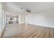 Open-concept living room with laminate floors, ceiling fan, and views of the kitchen at 7900 Holly Knoll Ave, Las Vegas, NV 89129