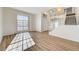 Bright living room with large windows, laminate flooring, and staircase to the upper level at 7900 Holly Knoll Ave, Las Vegas, NV 89129