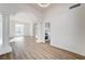 Spacious living room with laminate flooring, bright natural light, and decorative columns at 7900 Holly Knoll Ave, Las Vegas, NV 89129
