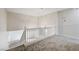 Hallway area with neutral carpet and a view to the staircase and chandelier at 7900 Holly Knoll Ave, Las Vegas, NV 89129