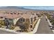 A high aerial view shows a neighborhood with a gray two-story home in a Primary-planned community at 8106 Skye Glen St, Las Vegas, NV 89166