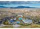Aerial view of a community, swimming pool, playground, and mountains in the distance at 8106 Skye Glen St, Las Vegas, NV 89166