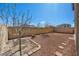 View of a zero-scaped backyard area with a young tree and a low brick wall at 8106 Skye Glen St, Las Vegas, NV 89166