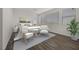 Bright bedroom showcasing a large window, wood floor, and light neutral furniture at 8106 Skye Glen St, Las Vegas, NV 89166