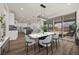 Open-concept dining room features modern light fixture and sliding doors to outdoor space at 8106 Skye Glen St, Las Vegas, NV 89166