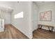 Hallway with a bench, artwork, wood floors and white walls at 8106 Skye Glen St, Las Vegas, NV 89166