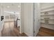 Bright hallway featuring an open door to the pantry and an open concept view of the kitchen at 8106 Skye Glen St, Las Vegas, NV 89166
