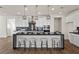 Stylish kitchen featuring white cabinets, black countertops, stainless steel appliances, and an island with seating at 8106 Skye Glen St, Las Vegas, NV 89166