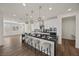 Modern kitchen boasts sleek white cabinets, a black countertop island, and stylish pendant lighting at 8106 Skye Glen St, Las Vegas, NV 89166
