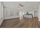 Expansive living area features sleek wood-look floors, white walls, and an open view into the kitchen at 8106 Skye Glen St, Las Vegas, NV 89166