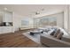 Inviting living room with wood-look flooring, a large sectional sofa, and an entertainment center at 8106 Skye Glen St, Las Vegas, NV 89166